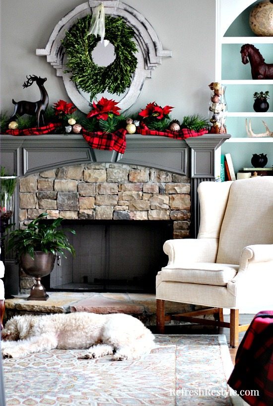 Christmas Mantel with real poinsettias and plaid at refreshrestyle.com