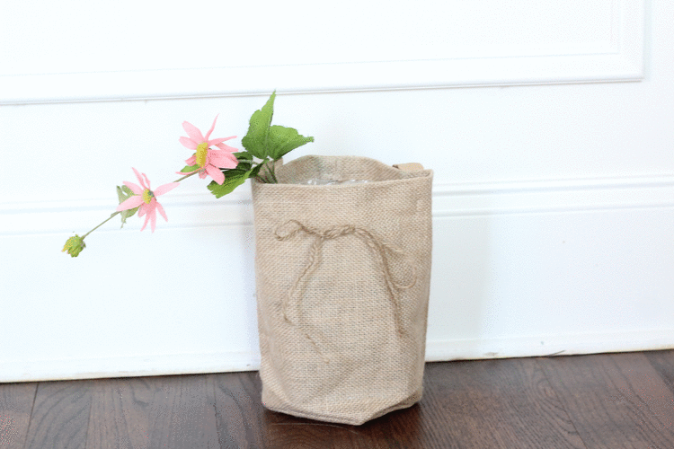 Flowers in a burlap bag for an awesome door decor idea!