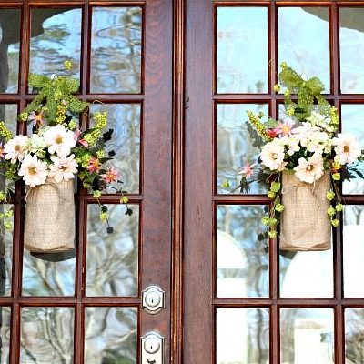 Double doors with pretty burlap bags filled with flowers