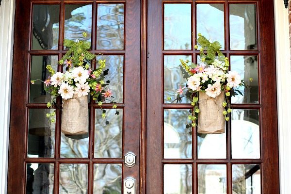 Double doors with pretty burlap bags filled with flowers