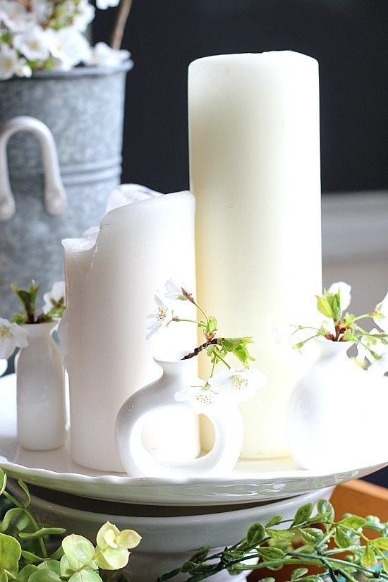 White candle and flowers layered in an old drawer on the table,