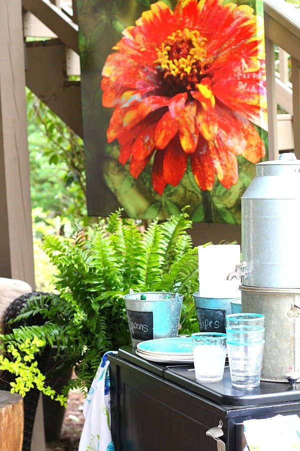 Patio serving area, silverware in buckets, aqua plates and cups