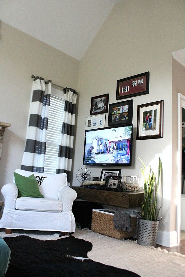 TV corner, baskets for storage and a snake plant