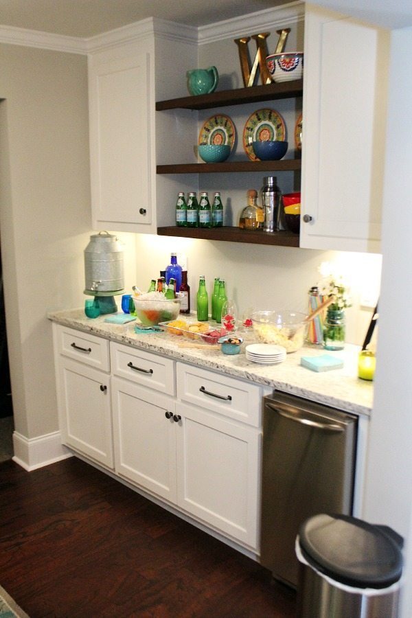 Basement makeover with serving area and ice machine Pub table made from metal and wood for the basement from BHG Walmart Kitchen area before From gutted to finished! Tips on decorating a kitchen in the basement! Light and bright for a basement.