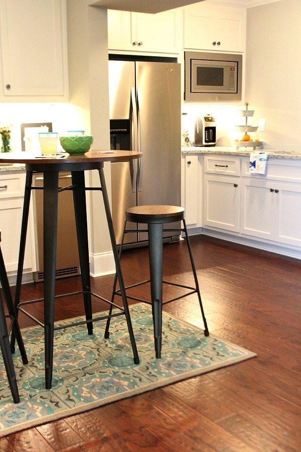 Pub table made from metal and wood for the basement from BHG Walmart Kitchen area before From gutted to finished! Tips on decorating a kitchen in the basement! Light and bright for a basement.