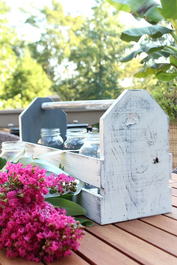 Rustic tote with flowers and mason jars for centerpiece