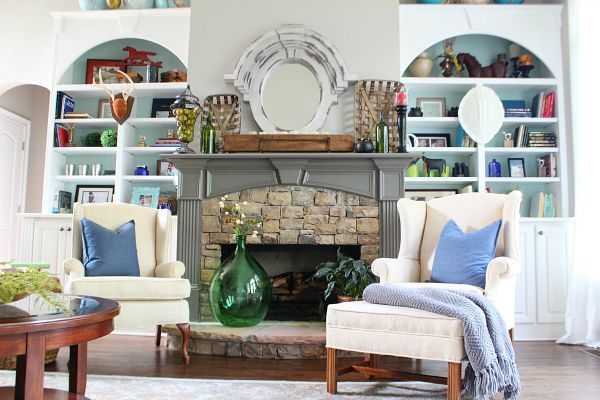 Dual bookcases surrounding a stone fireplace styling tips at refreshrestyle.com