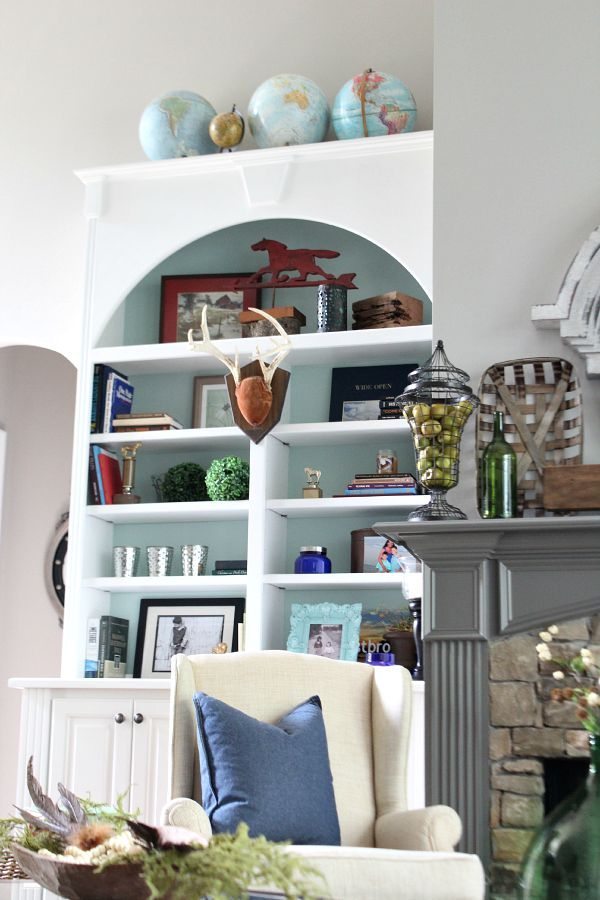 Globes, antlers, horses and books - tips for your bookcase styling at refreshrestyle.com