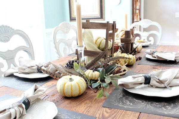 Pumpkins and feathers and crates make a wonderful fall harvest table refreshrestyle.com