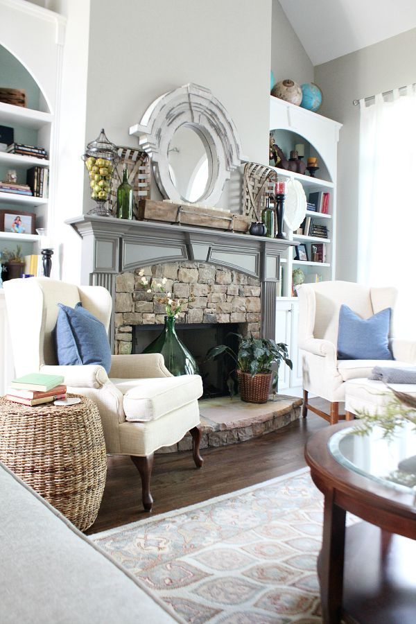 Stone fireplace flanked by bookcases at refreshrestyle.com