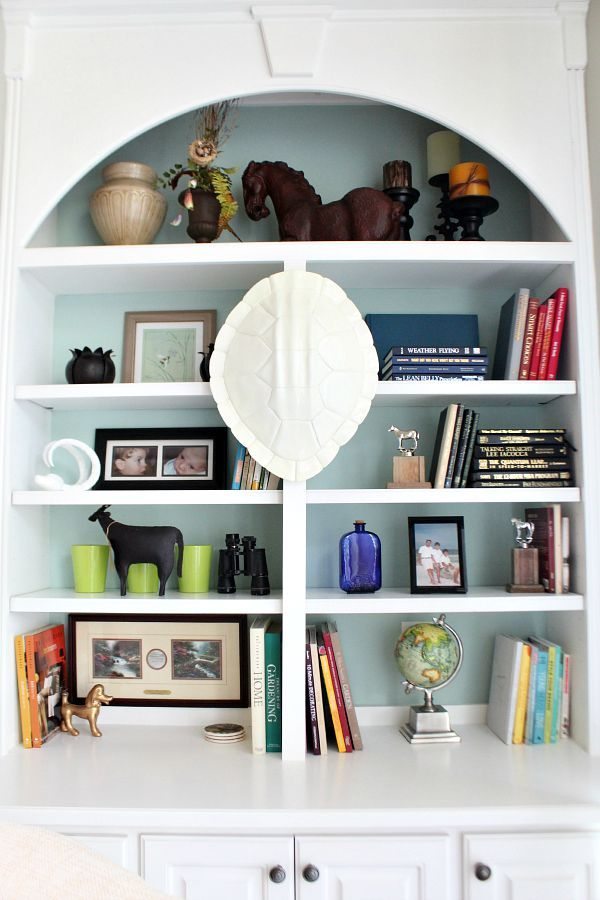 Tips for styling bookcases with items that you collect from refreshrestyle.com