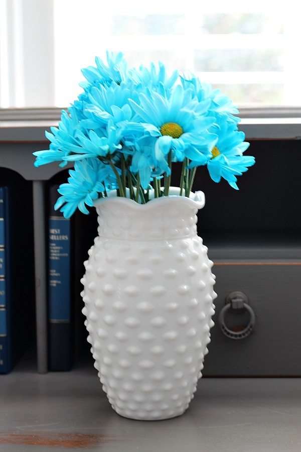 Aqua flowers in a hob knob milk glass vase at refreshrestyle.com