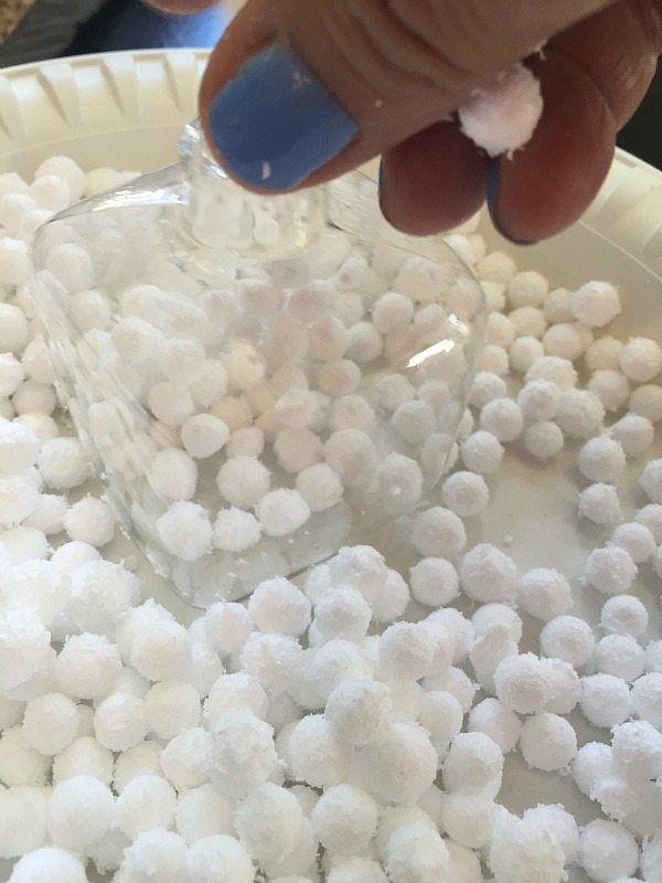 Filling glass ornaments with snowballs at refreshrestyle.com