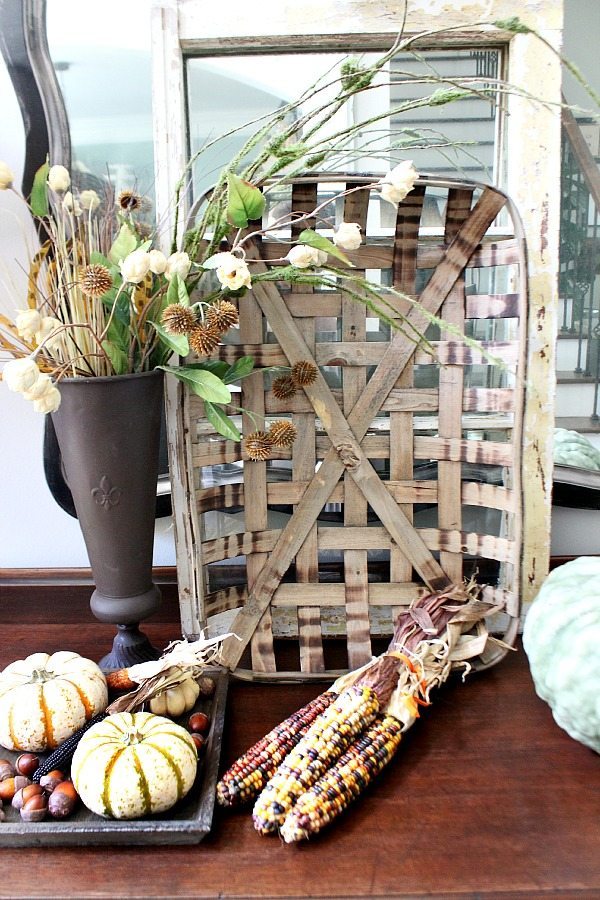 Indian Corn and woven baskets for fall in the entry at refreshrestyle.com