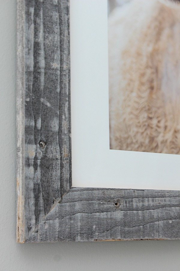 Real barnwood frame on art above guest room bed