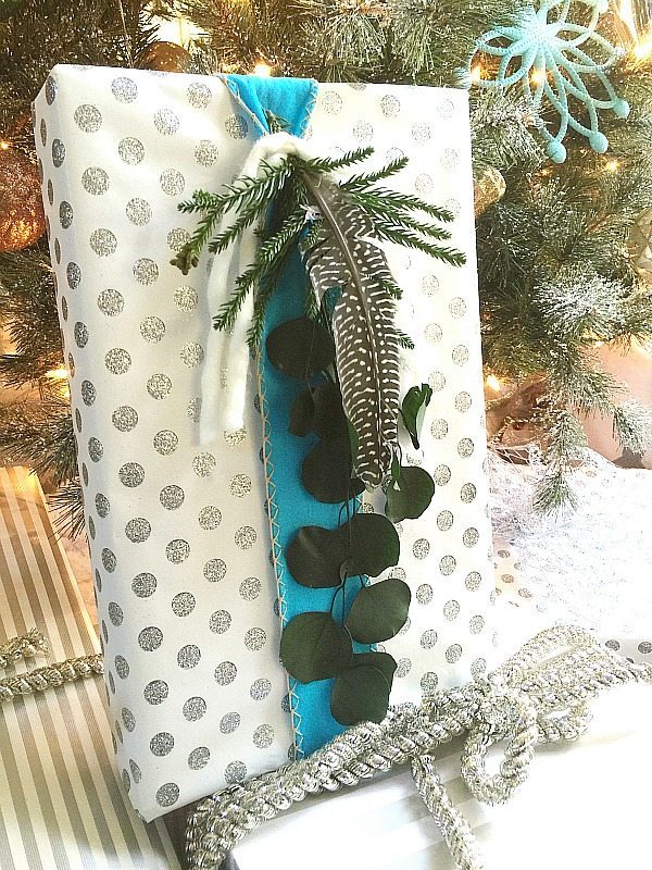 Greenery, blue ribbon for a natural Christmas gift wrapping idea