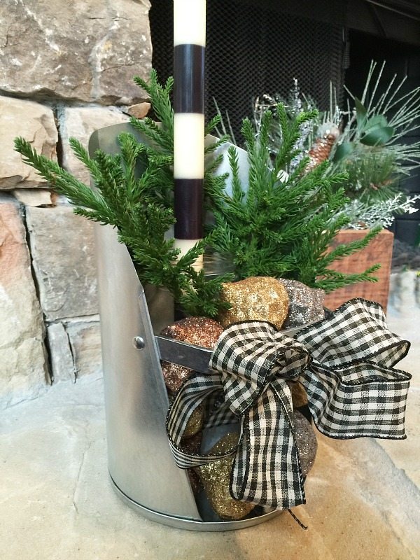 Mason jar, feed scoop, candle and greenery perfect for Christmas decor