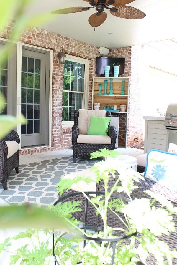 Summer patio with tv and build in grill area at RefreshRestyle.com