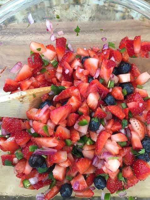 Toss the ingredients for the strawberry blueberry salsa recipe