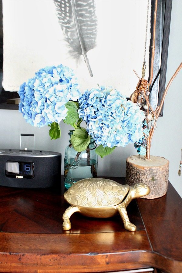 Aqua mason jar filled with hydrangeas on the night stand