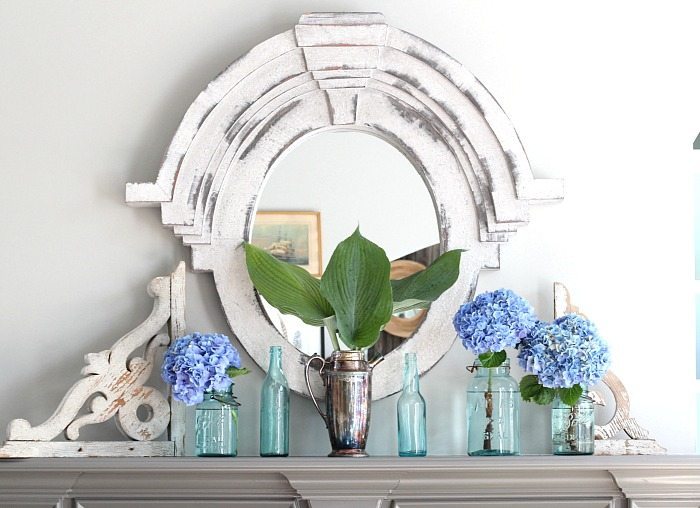 Aqua mason jars and soda bottles are perfect for holding hydrangeas on the mantel