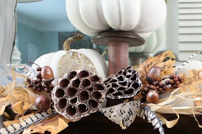 Painted faux pumpkins with seed pods and feathers for fall at Refresh Restyle
