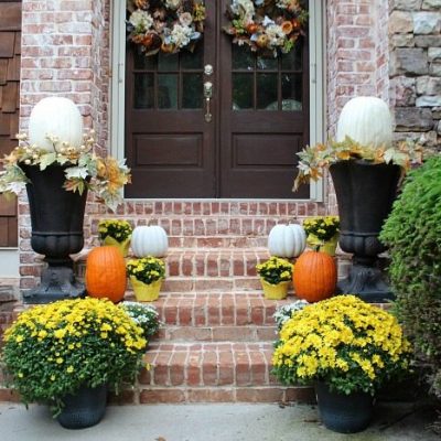 orange-and-white-pumpkins-flanked-by-yellow-and-white-mums-perfect-for-fall-entry