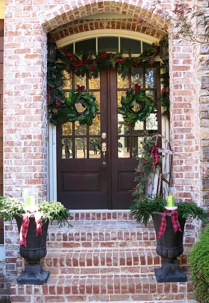 Farmhouse plaid and magnolias make a pretty Christmas Welcoming Door