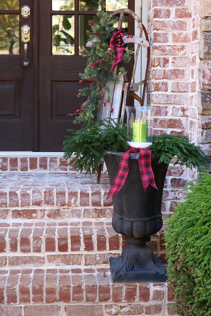 fill-an-urn-with-greenery-and-candles-and-plaid-ribbon-for-a-rustic-look-for-christmas