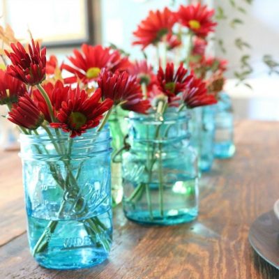 green-and-blue-mason-jars-filled-with-flowers