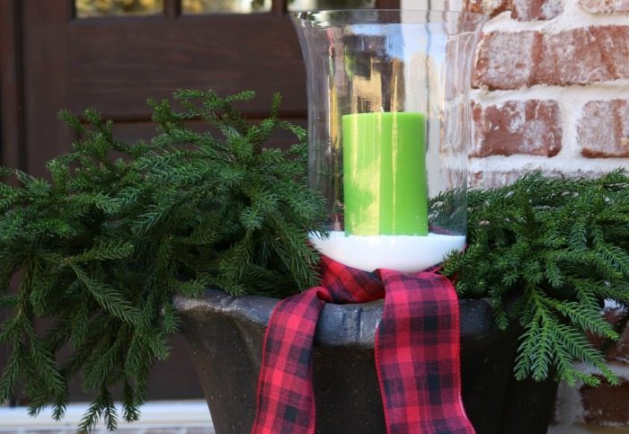 green-candles-greenery-and-plaid-ribbon-for-the-christmas-front-porch