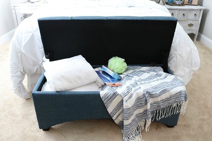 Put a bench at the foot of the bed, perfect for storing all the extras for guest and great place to sit