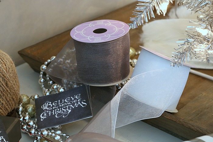 Soft ribbon in gray and white make pretty bows for Christmas presents