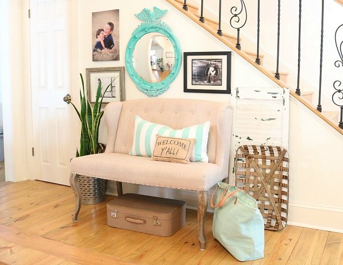 Family photos and collected thrifty items for the entry plus a turquoise federal convex mirror