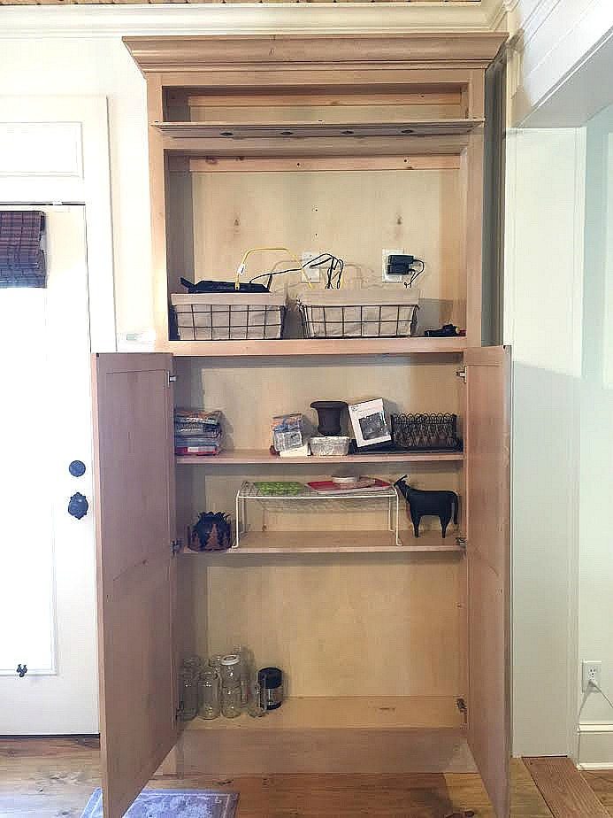 Former tv cabinet is now a mudroom drop zone