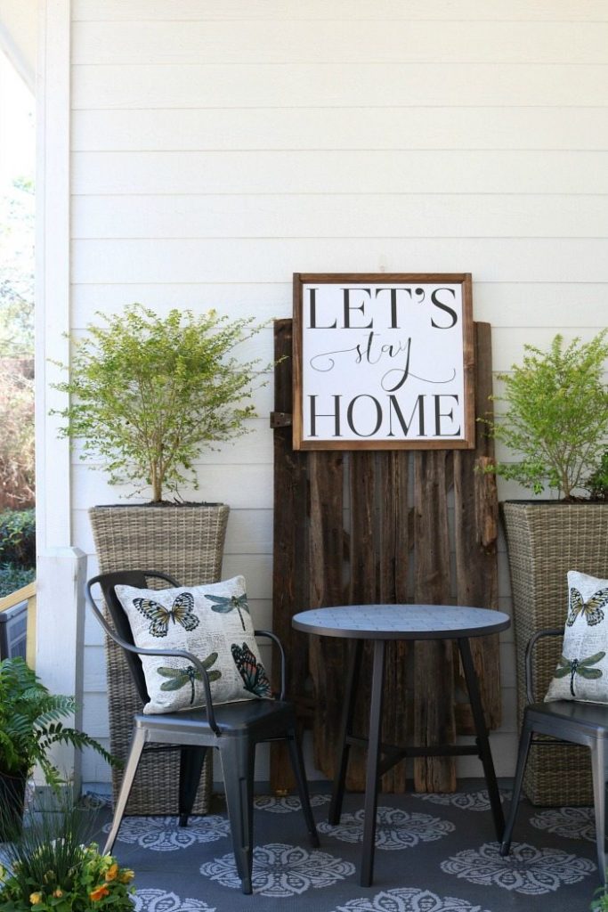 Shiplap barn wood metal chairs make a great conversation area on the porch at the Alabama Farmhouse