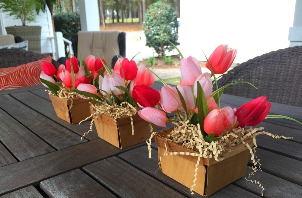 Farmhouse centerpiece created with berry baskets and tulips