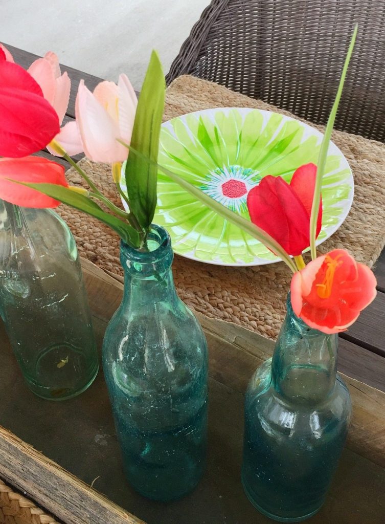 Spring colors with aqua glass bottles and tulips