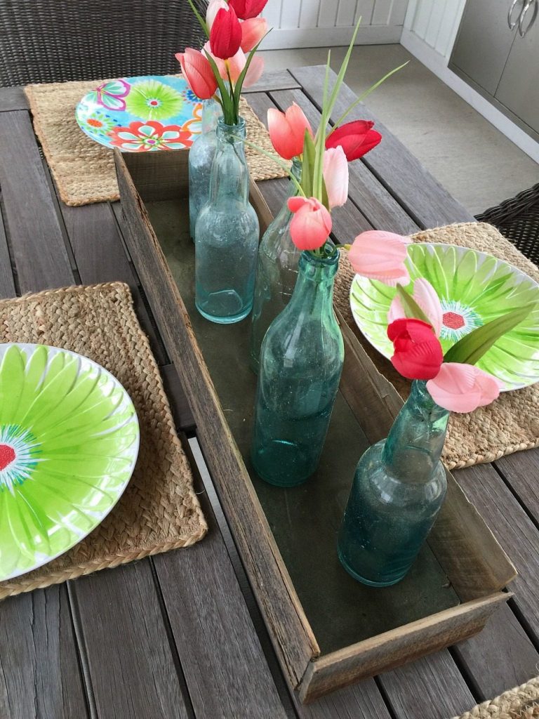 farmhouse dining table with old blue bottles