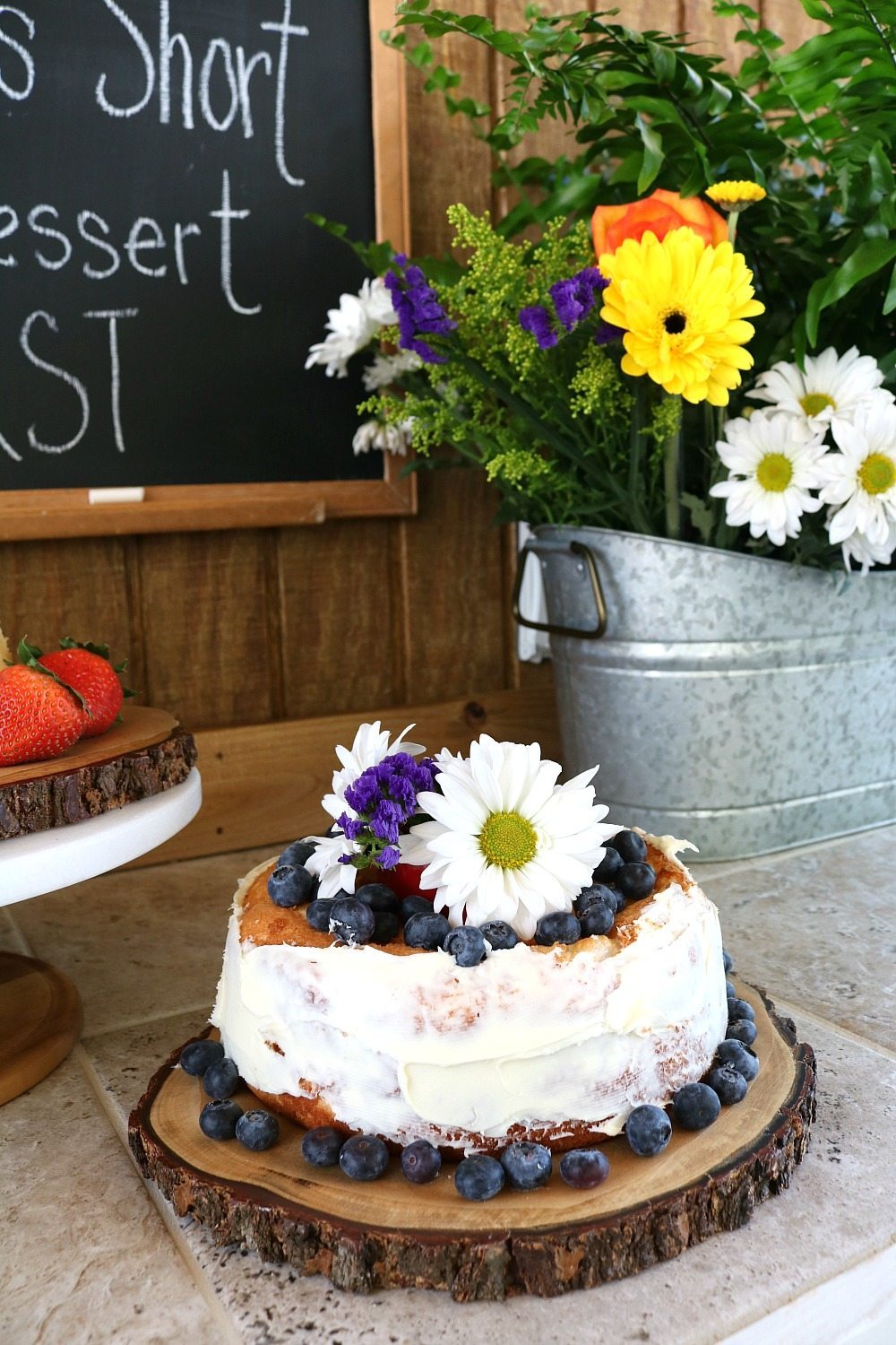 Farmhouse desserts served on wood slices with flowers in galvanized tub