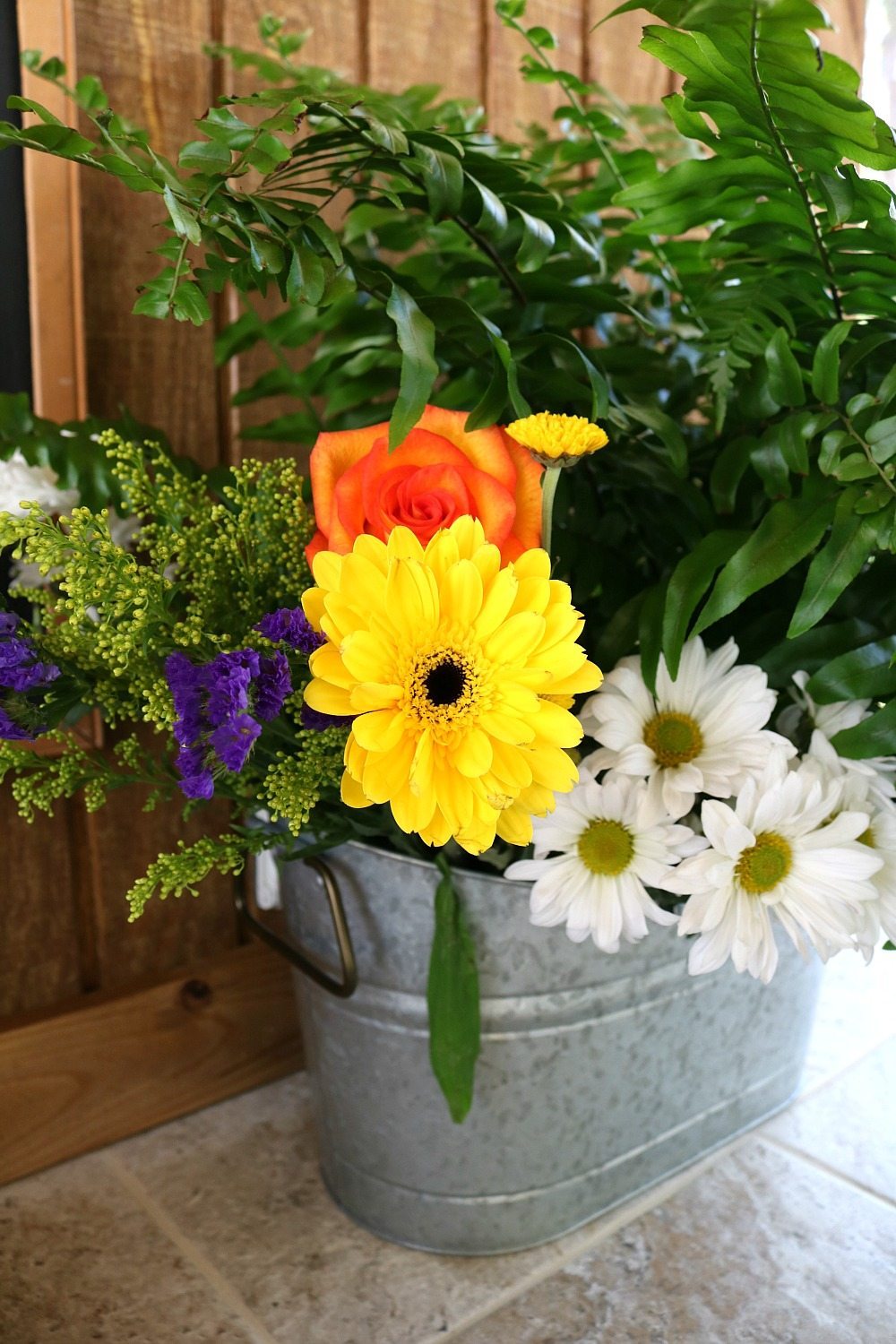 Farmhouse flowers in a galvanized bucket perfect for any decor