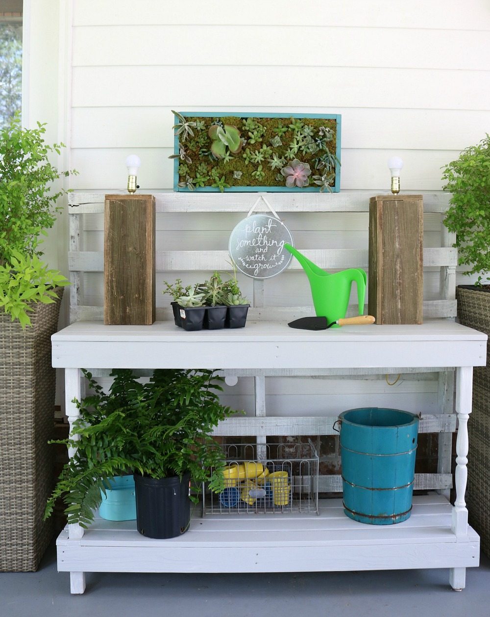 Potting table made from pallets with a vertical succulent garden perfect for the back porch