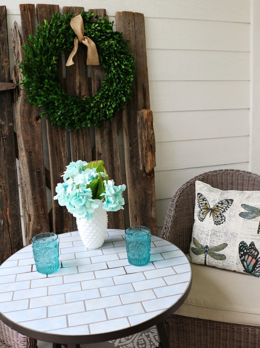 Barn door with boxwood wreath for the farmhouse porch at Refresh Restyle