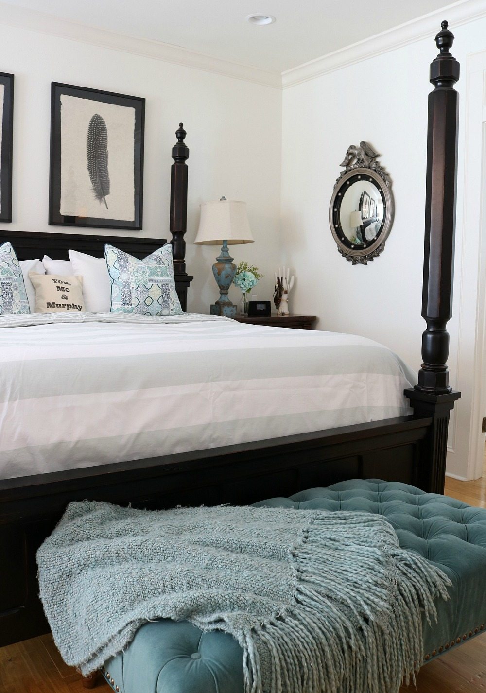 Federal eagle mirror in a white bedroom with black accents