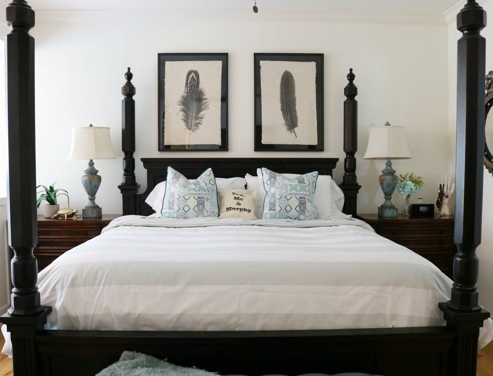 Four poster black bed with blue and white bedding