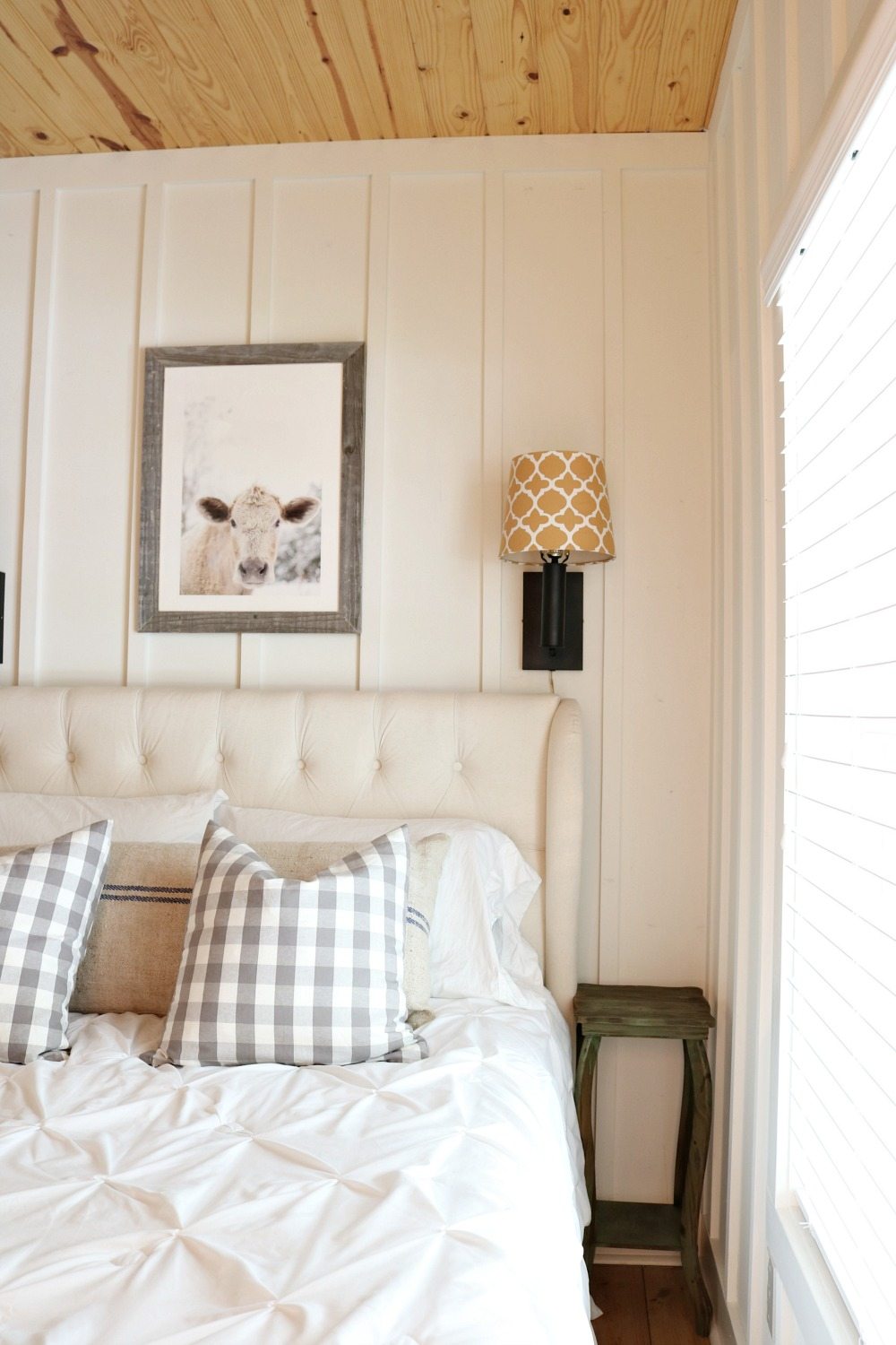 Farmhouse bedroom with lights above the bed