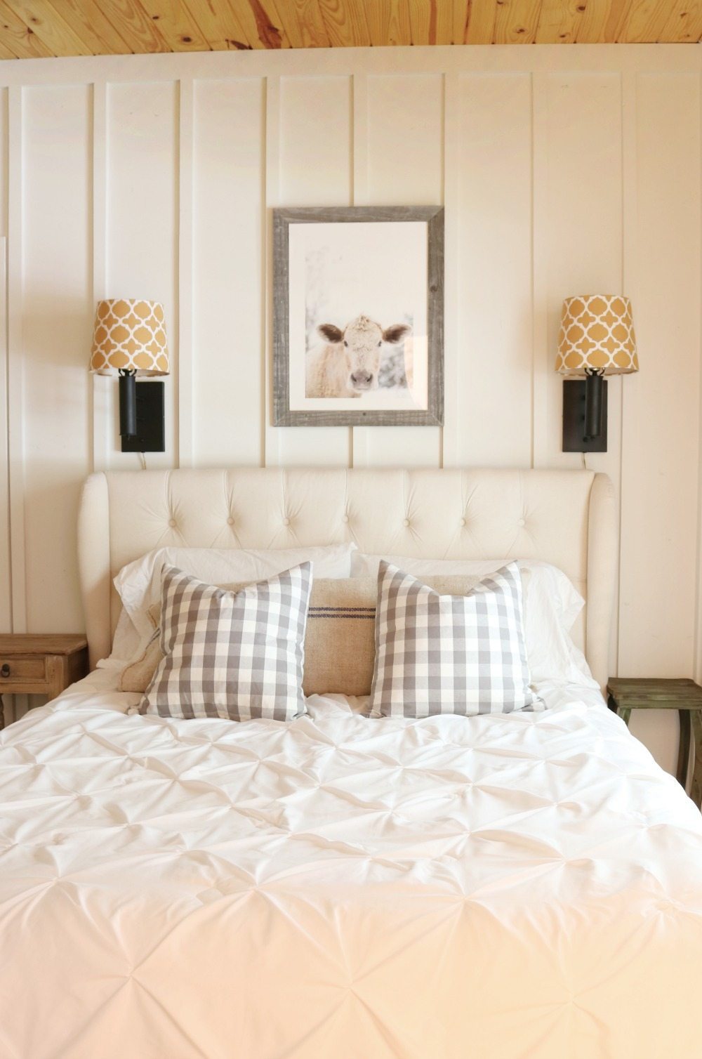 Lamps above the bed in the farmhouse bedroom