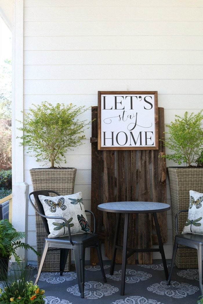 Shiplap-barn-wood-metal-chairs-make-a-great-conversation-area-on-the-porch-at-the-Alabama-Farmhouse-1