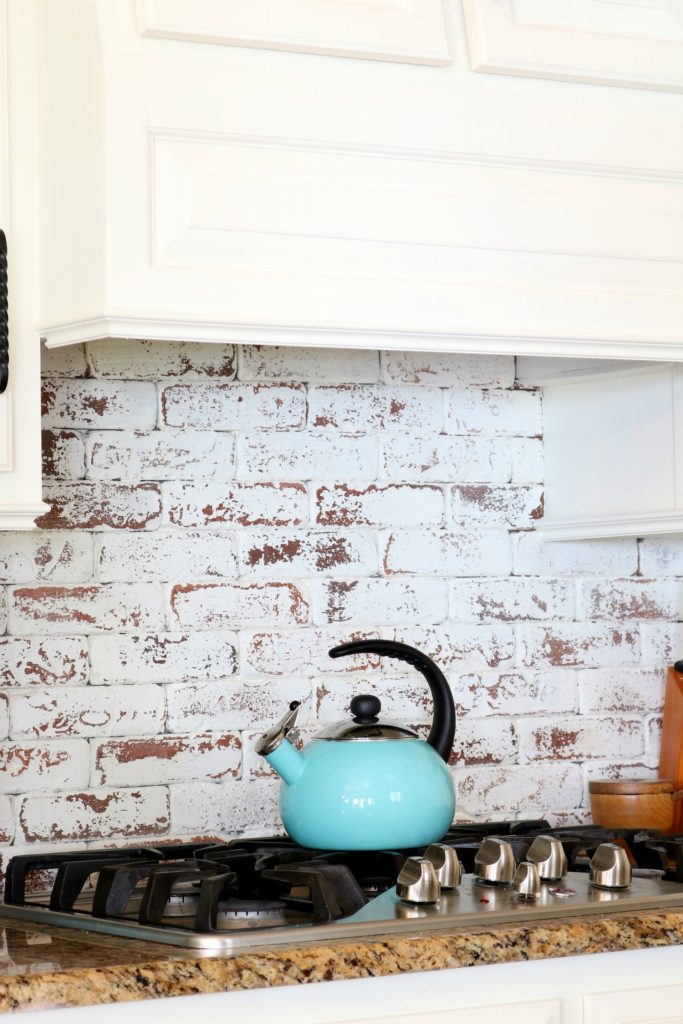 Real bricks painted and distressed behind cooktop