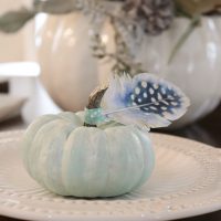 Tiny blue pumpkins with paper feathers